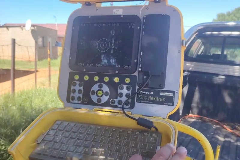 An ARPCO operator working the CCTV control unit on the back of a bakkie at a job, with the camera's live picture on the screen.